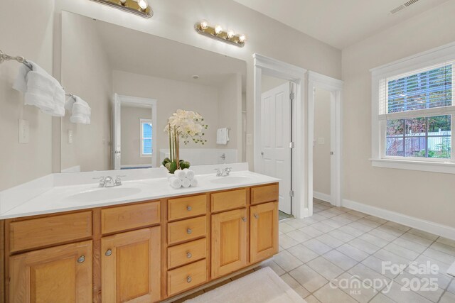 bathroom with tile patterned floors and vanity