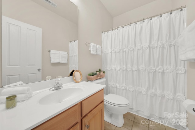 bathroom featuring tile patterned floors, vanity, and toilet