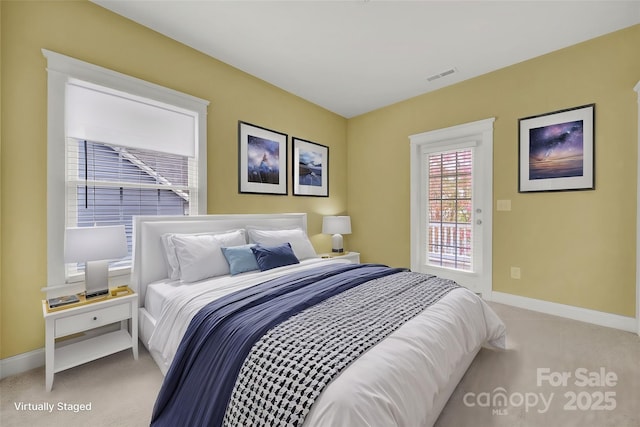 bedroom featuring light carpet and access to outside