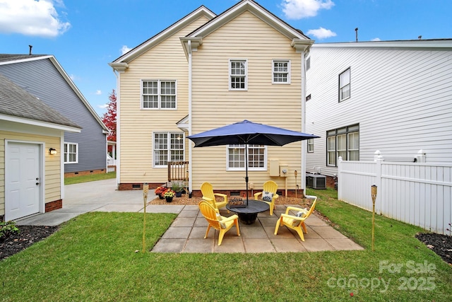 rear view of property with a fire pit, a patio area, central air condition unit, and a lawn