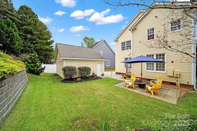 rear view of house with a lawn, a patio area, an outdoor structure, and an outdoor fire pit