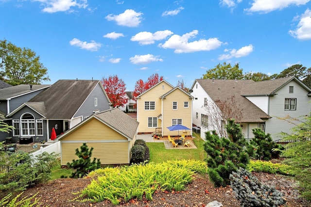 back of property featuring a lawn and a patio