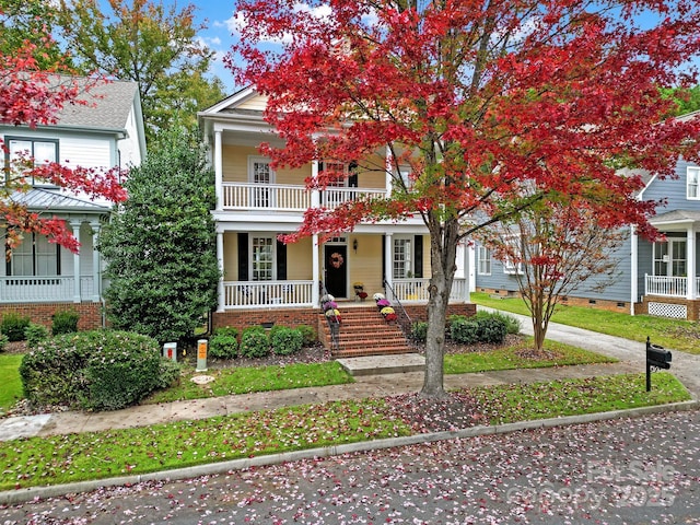 view of front of property featuring a porch and a balcony