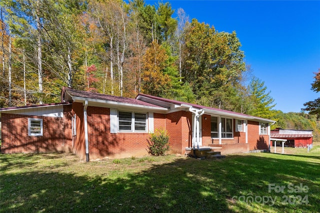 ranch-style house with a front lawn