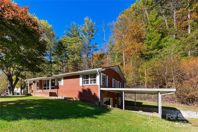 view of property exterior with a yard and a carport