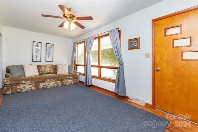 living room featuring hardwood / wood-style flooring and ceiling fan