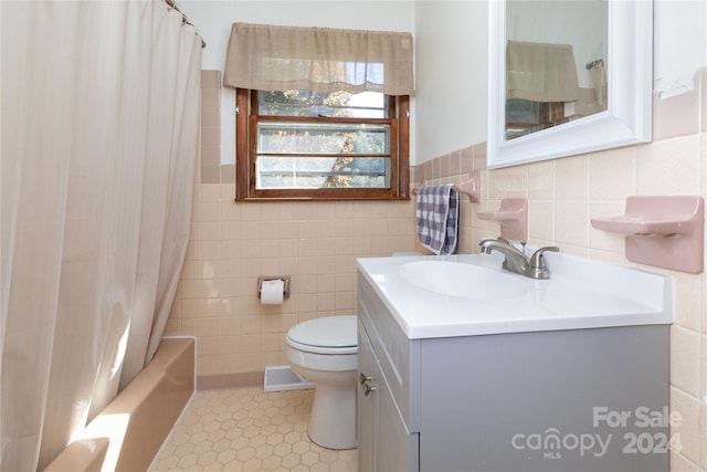 full bathroom featuring tile walls, vanity, shower / bath combo with shower curtain, and toilet