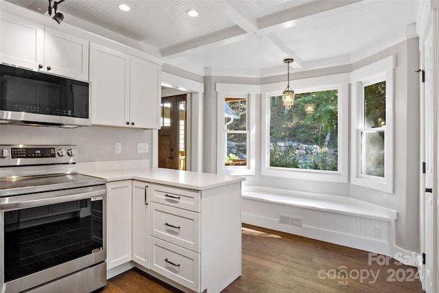 kitchen with stainless steel appliances, light countertops, white cabinets, dark wood-type flooring, and visible vents