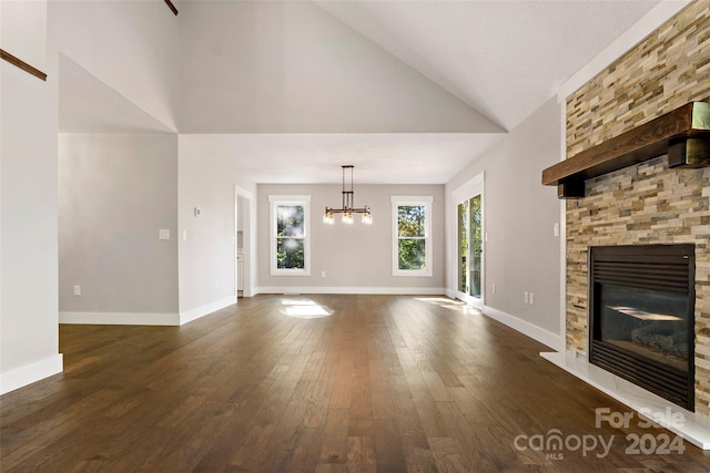 unfurnished living room with high vaulted ceiling, baseboards, dark wood-style flooring, and a fireplace