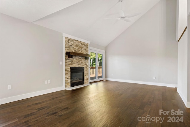 unfurnished living room with a stone fireplace, ceiling fan, high vaulted ceiling, and dark hardwood / wood-style flooring