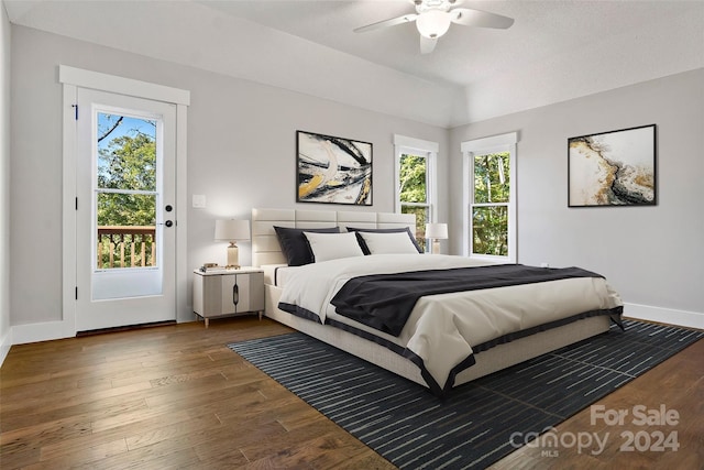 bedroom with ceiling fan, wood finished floors, baseboards, and multiple windows