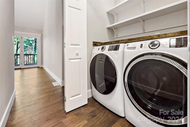 laundry area with dark wood finished floors, separate washer and dryer, baseboards, and laundry area