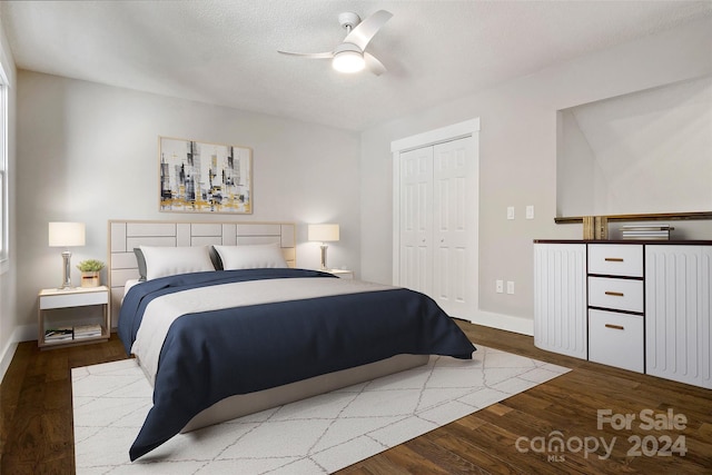 bedroom featuring hardwood / wood-style floors, a textured ceiling, a closet, and ceiling fan