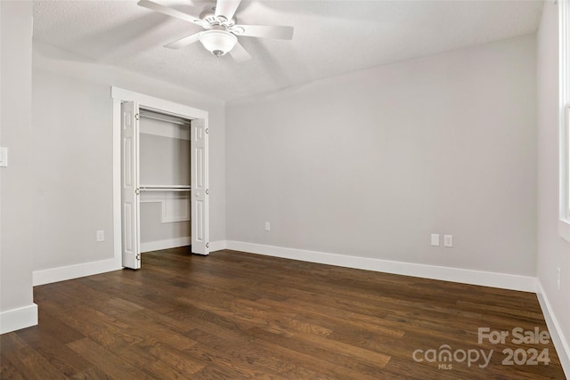 unfurnished bedroom featuring a closet, ceiling fan, a textured ceiling, and dark hardwood / wood-style flooring