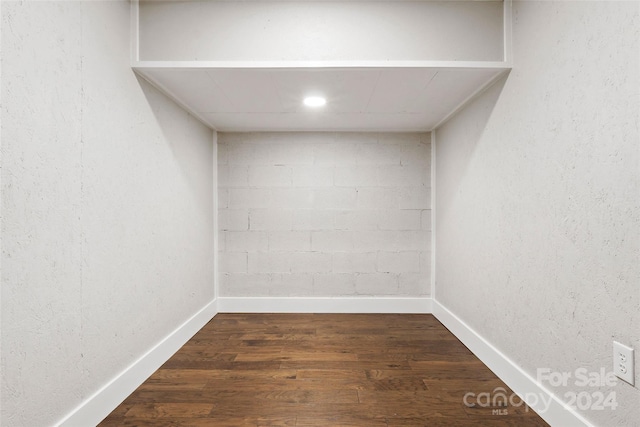 empty room featuring baseboards and wood finished floors