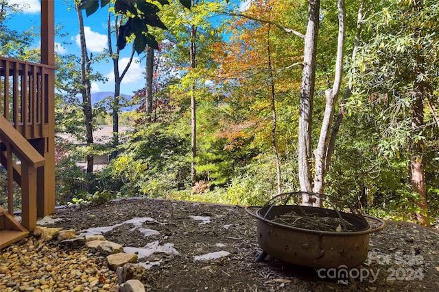 view of yard featuring a mountain view and a fire pit