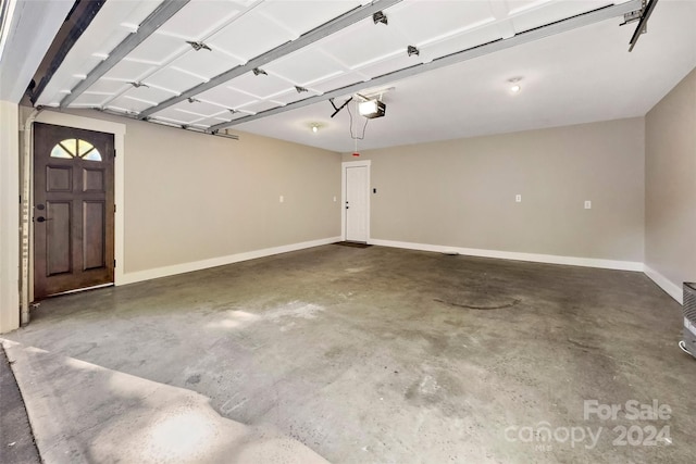 garage featuring baseboards and a garage door opener