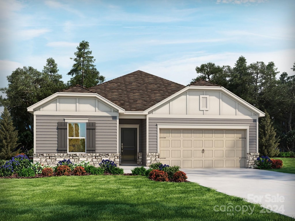 view of front of house with a front lawn and a garage