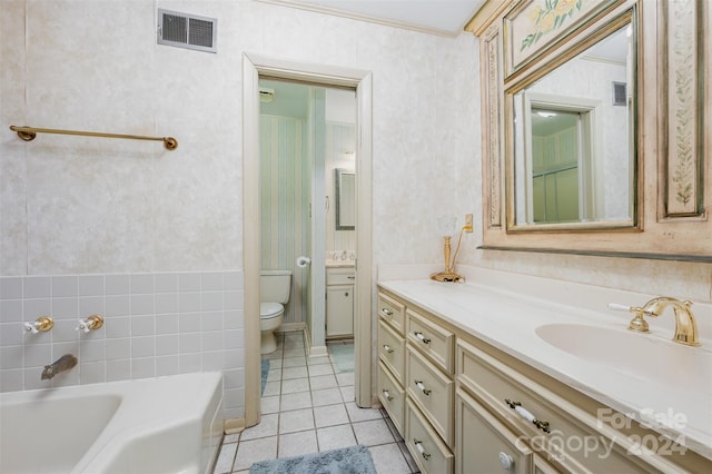 bathroom with vanity, tile patterned floors, toilet, and a washtub