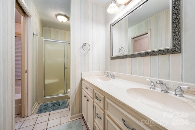 bathroom featuring a shower with door, toilet, tile patterned flooring, and vanity