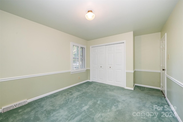 unfurnished bedroom with carpet floors and a closet