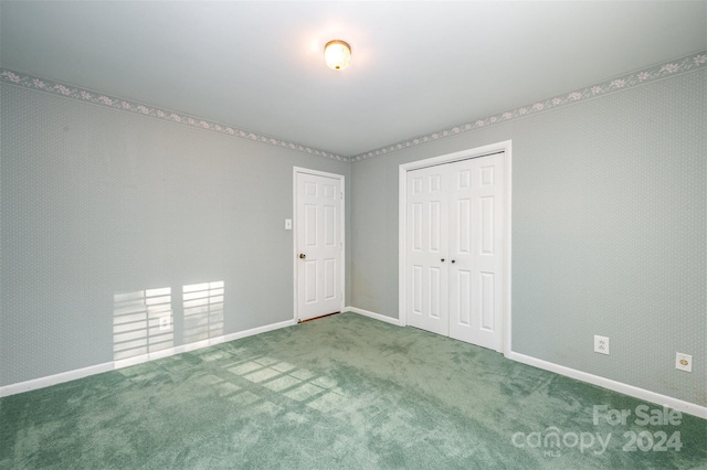 unfurnished bedroom featuring a closet and carpet