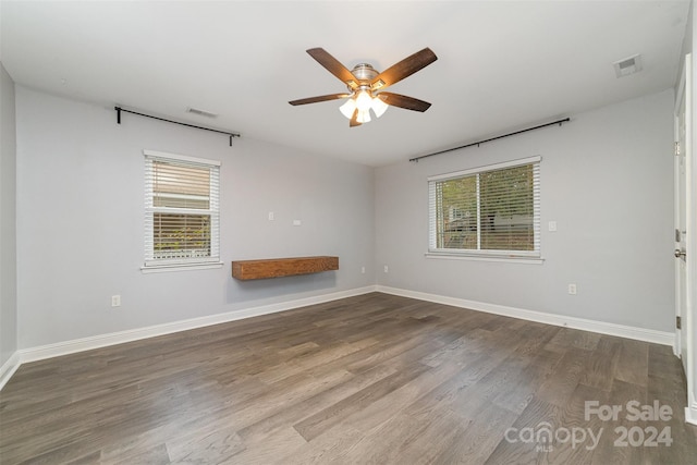 unfurnished room with hardwood / wood-style flooring, plenty of natural light, and ceiling fan