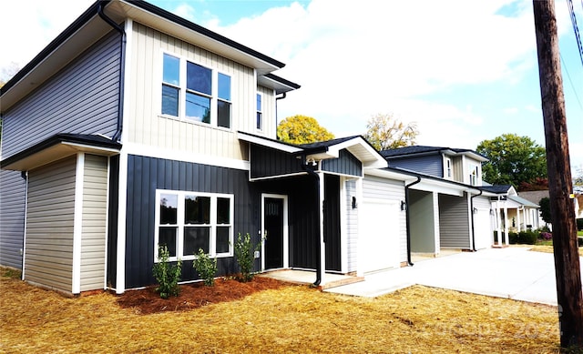 rear view of property with a garage