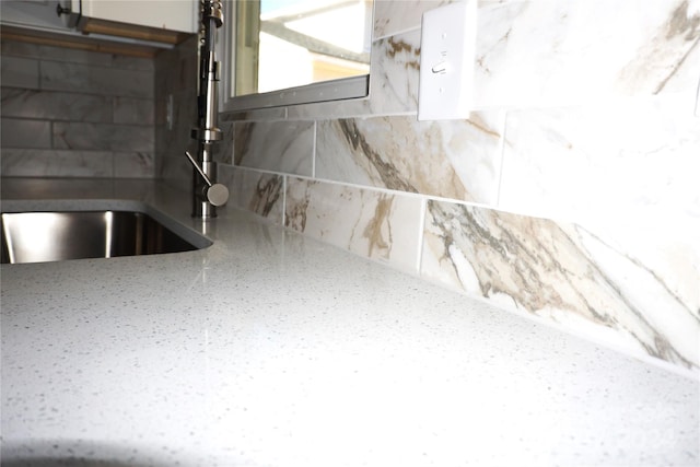 interior details featuring tasteful backsplash and sink