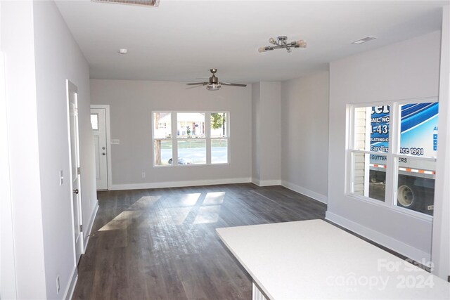 interior space featuring ceiling fan and dark hardwood / wood-style flooring