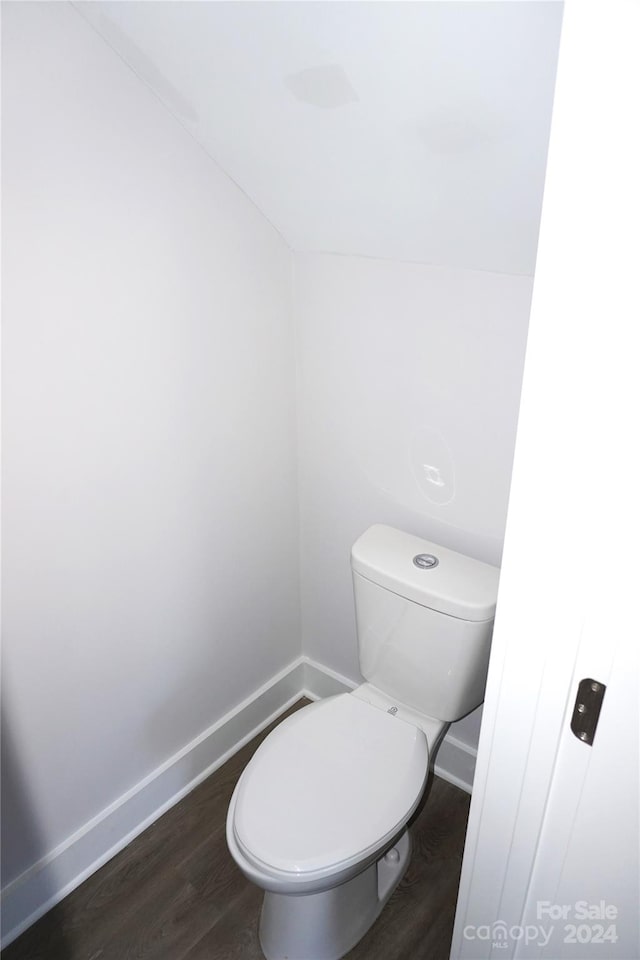 bathroom featuring toilet and wood-type flooring