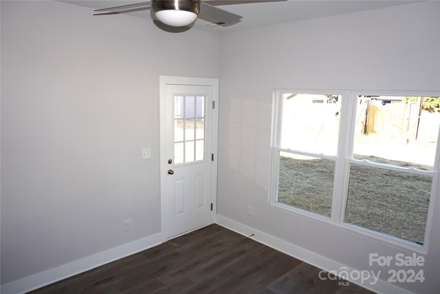 doorway featuring ceiling fan and dark hardwood / wood-style flooring