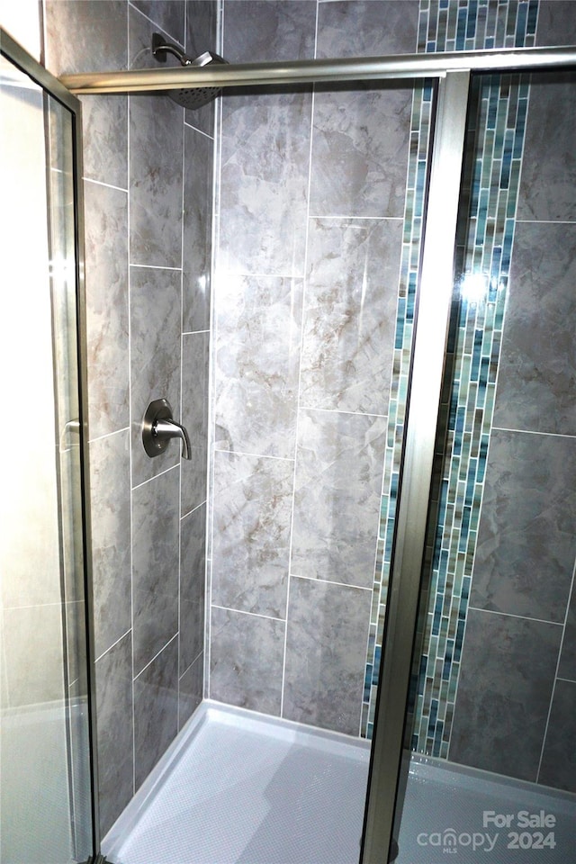 bathroom with a shower with shower door