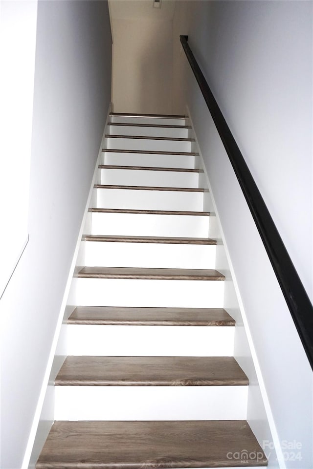 stairs with wood-type flooring