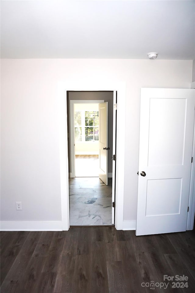 hallway featuring dark hardwood / wood-style flooring