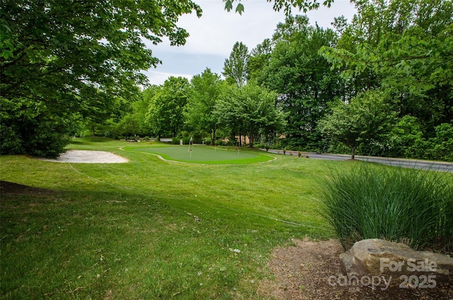 view of home's community featuring a yard and view of golf course