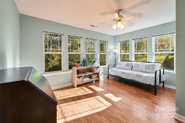 sunroom with ceiling fan and visible vents