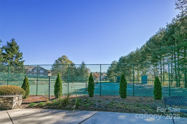 view of sport court featuring fence