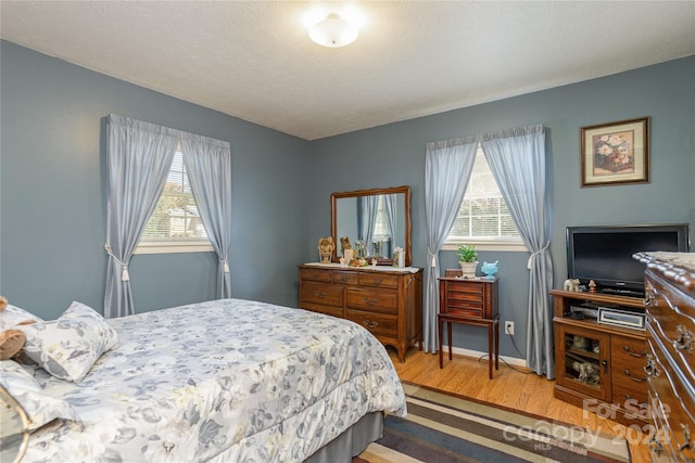 bedroom featuring a textured ceiling and wood-type flooring