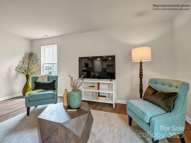 sitting room with hardwood / wood-style flooring