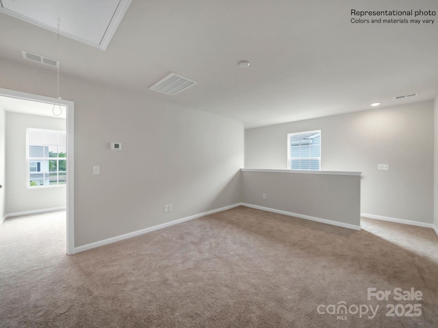 unfurnished room with light carpet and a healthy amount of sunlight