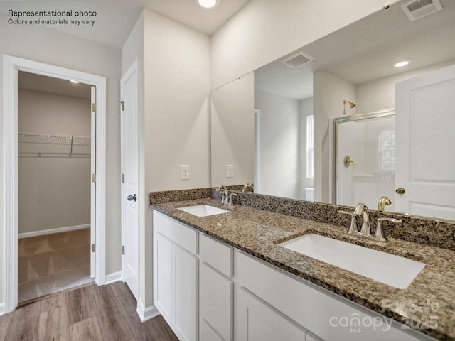 bathroom featuring vanity, hardwood / wood-style flooring, and an enclosed shower