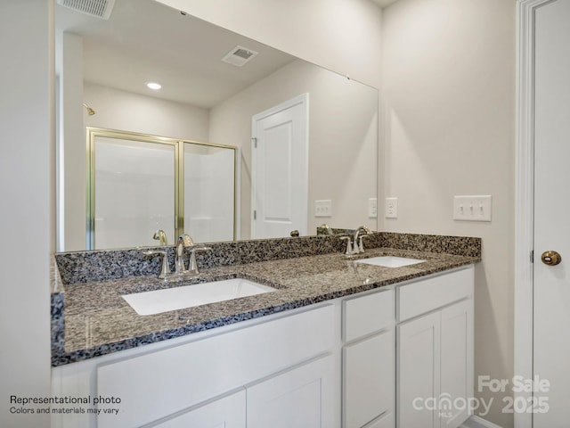 bathroom featuring an enclosed shower and vanity