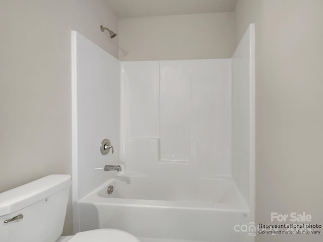 bathroom featuring toilet and bathing tub / shower combination