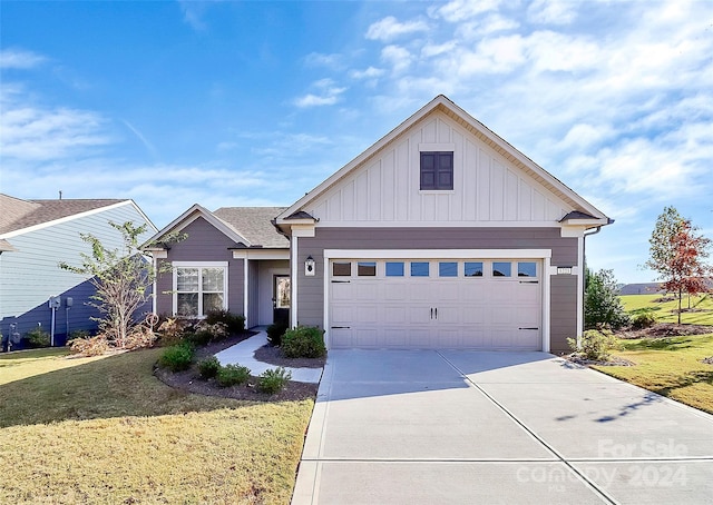 view of front of property with a front yard and a garage