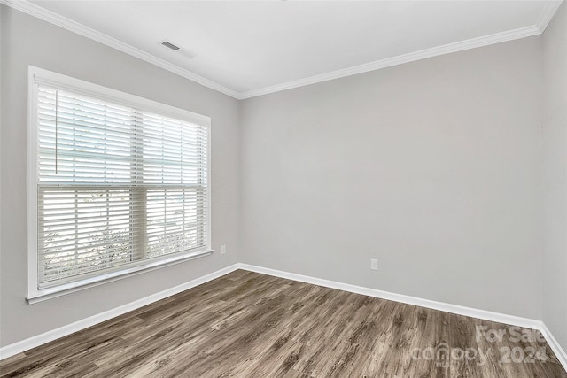 unfurnished room featuring crown molding and wood-type flooring