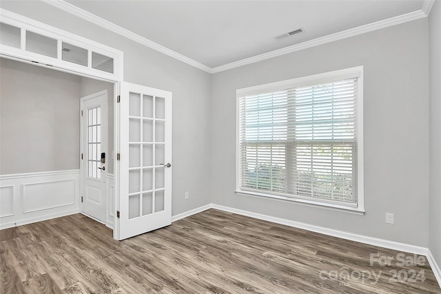 spare room with ornamental molding, french doors, and hardwood / wood-style flooring