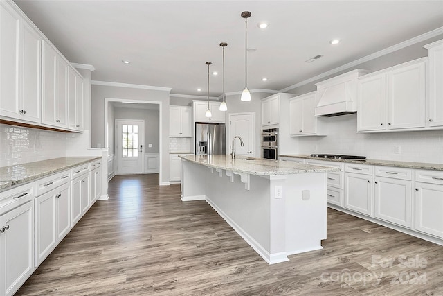 kitchen featuring custom exhaust hood, a kitchen island with sink, stainless steel appliances, and dark wood-type flooring