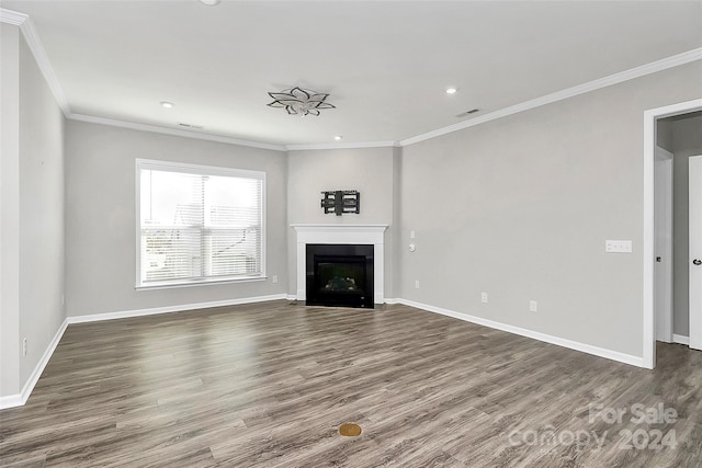 unfurnished living room featuring ornamental molding and dark hardwood / wood-style floors