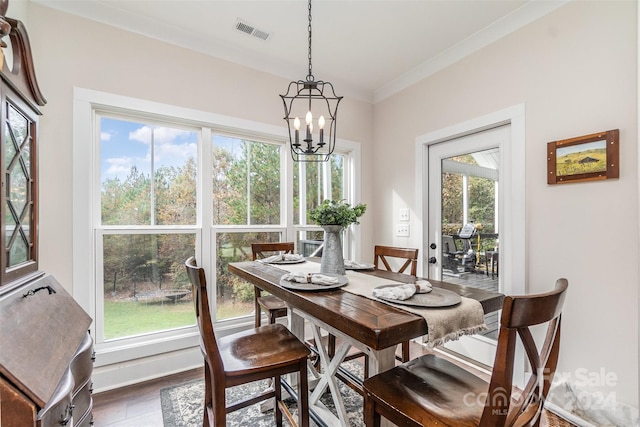 dining room with crown molding, a notable chandelier, plenty of natural light, and dark hardwood / wood-style floors